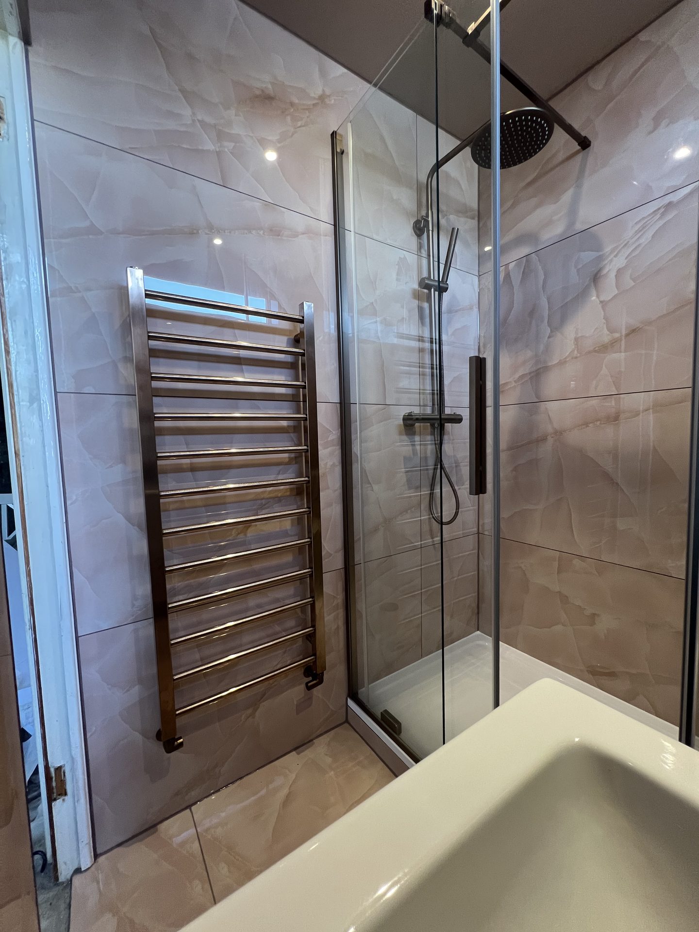 Rainfall shower head and heated towel rail detail