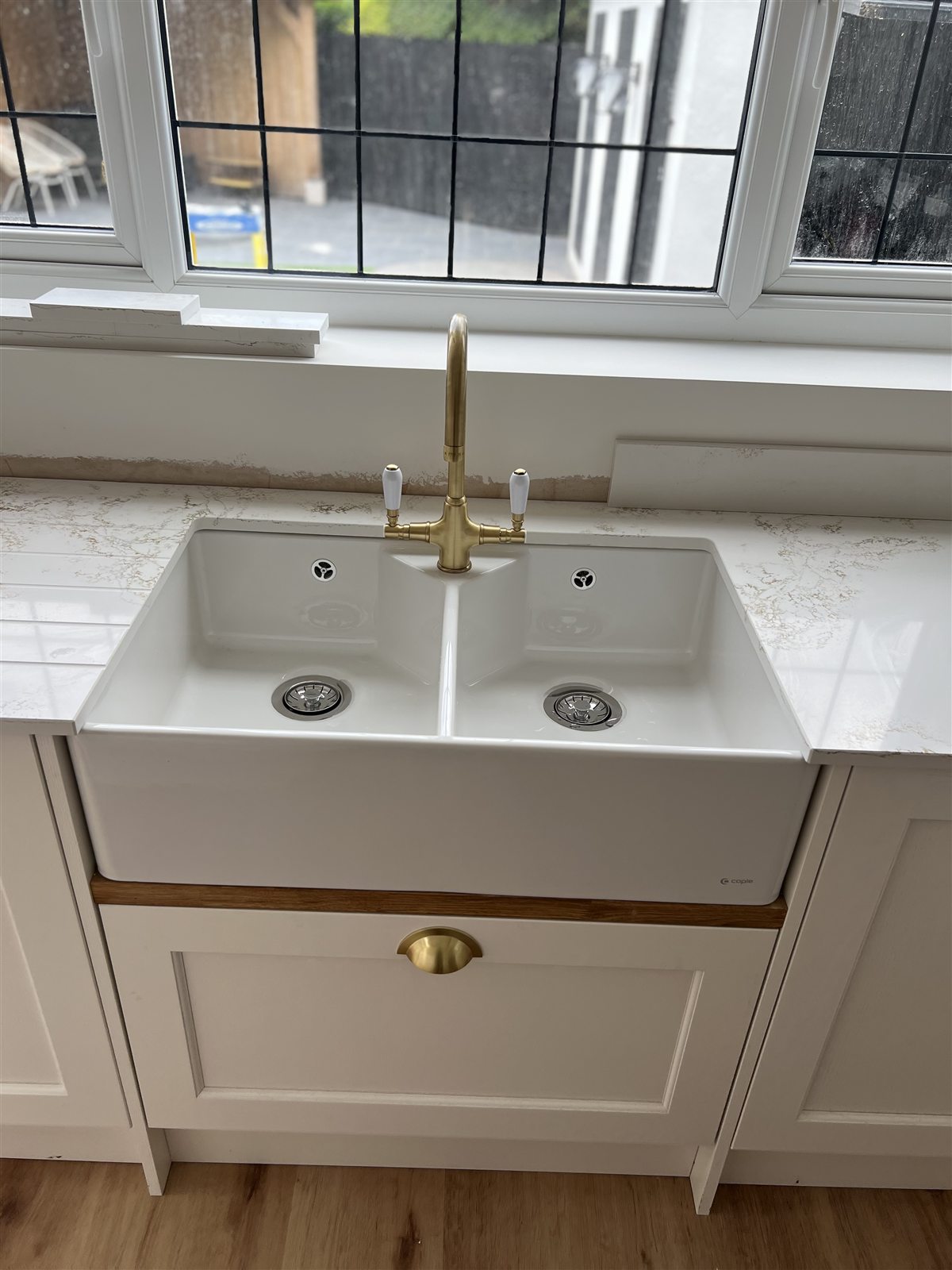 Belfast-style ceramic sink with brass mixer tap